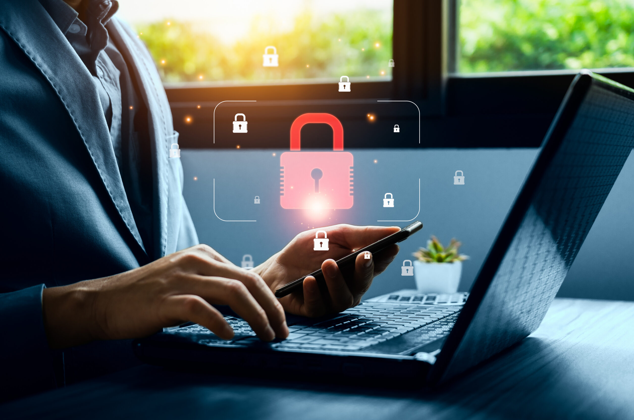 A person using a laptop and smartphone with a padlock icon representing secure access to a website